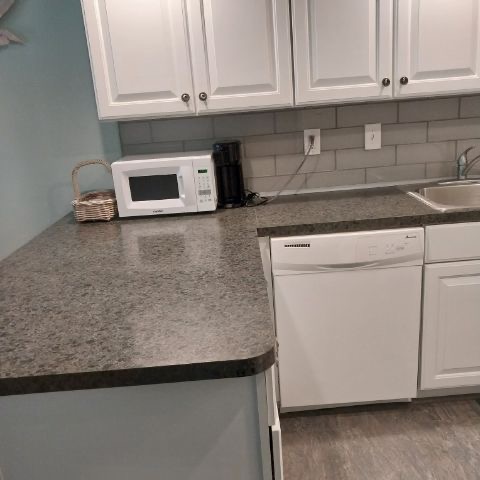 Kitchen counter with dishwasher microwave and coffee maker